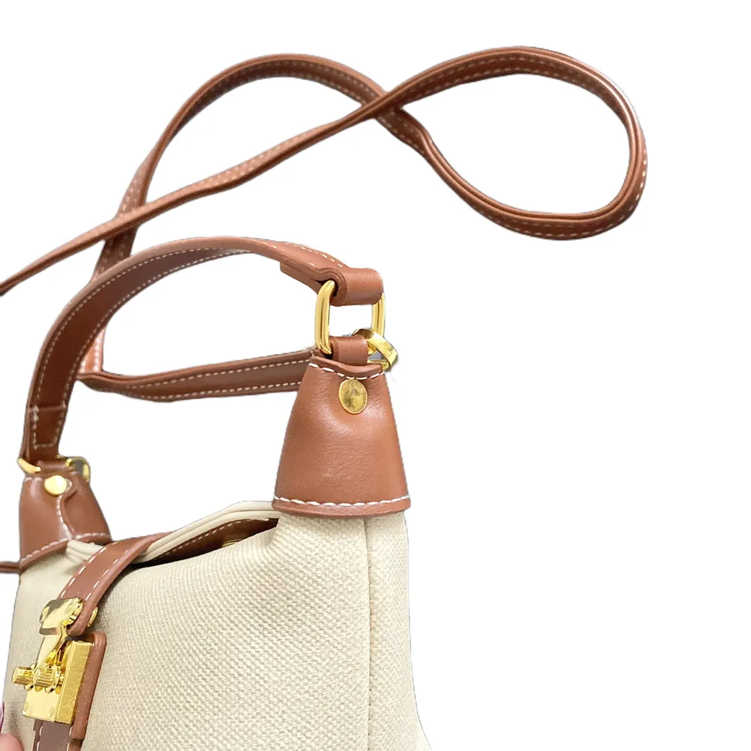 Gold-tone clasps and fine stitching detail on the hobo bag strap