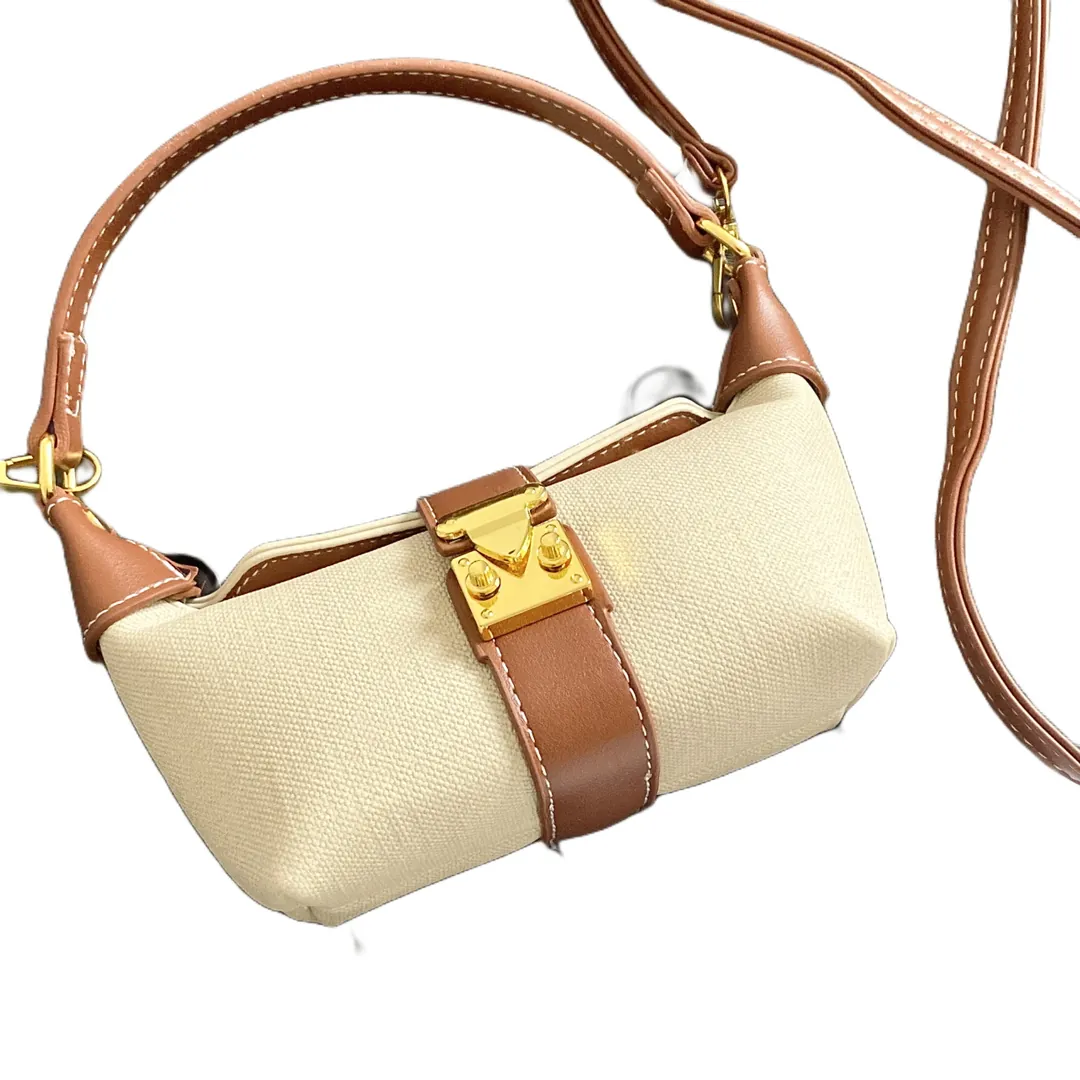 Textured fabric body with PU leather trim and gold turn-lock on the front